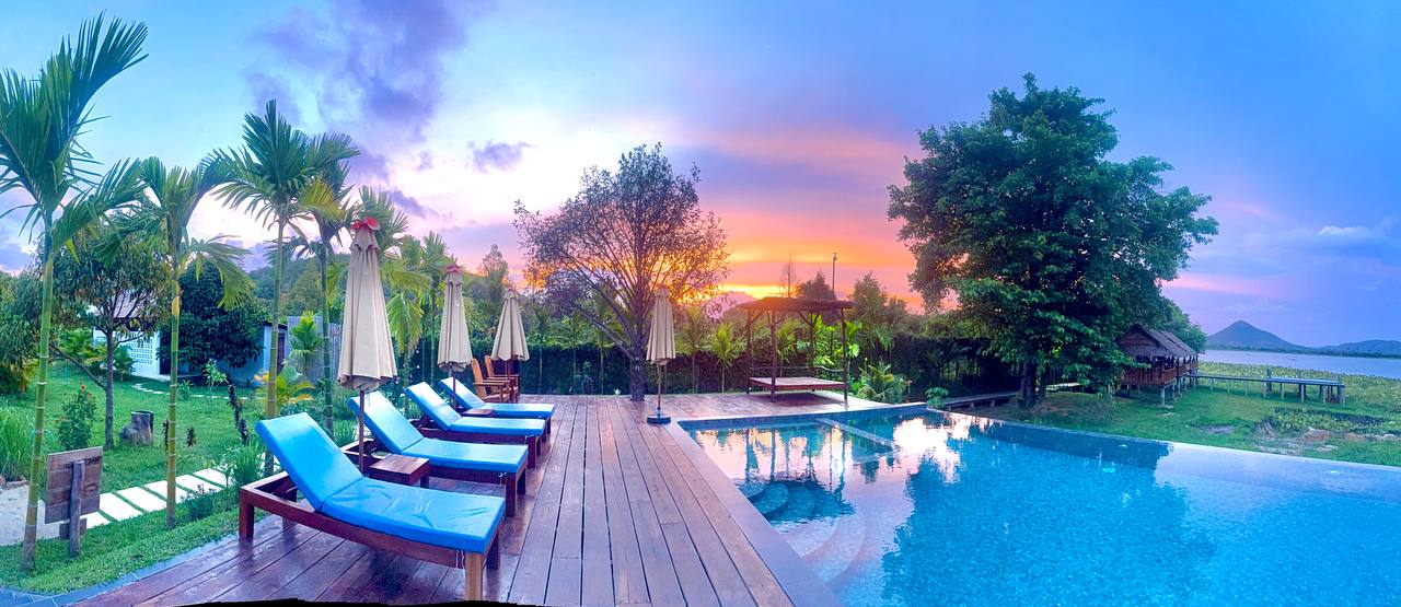 Pool, restaurant, and lakeside view at Secret Lake House